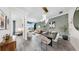 Modern open-concept living room with dining area, stylish decor, and plenty of natural light at 774 Gran Kaymen Way, Apollo Beach, FL 33572