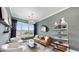 Bright living room with a decorative chandelier, large windows, and modern furniture at 774 Gran Kaymen Way, Apollo Beach, FL 33572