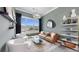 Bright living room with a decorative chandelier, large windows, and modern furniture at 774 Gran Kaymen Way, Apollo Beach, FL 33572