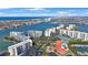 Breathtaking aerial view of waterfront condos featuring lush landscaping, tennis courts, and boat docks at 7892 Sailboat Key S Blvd # 307, South Pasadena, FL 33707