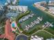 Picturesque aerial view featuring a marina with boats, tennis courts, and well-manicured landscaping at 7892 Sailboat Key S Blvd # 307, South Pasadena, FL 33707