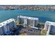 Aerial view of a condo complex with manicured landscaping, convenient parking, and stunning water access at 7892 Sailboat Key S Blvd # 307, South Pasadena, FL 33707