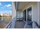 Relax on this spacious balcony with serene water views and comfortable seating, accessible through sliding glass doors at 7892 Sailboat Key S Blvd # 307, South Pasadena, FL 33707