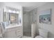 Bright bathroom features glass enclosed shower, vanity with sink and tile floor at 7892 Sailboat Key S Blvd # 307, South Pasadena, FL 33707