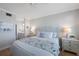Calming bedroom is decorated in soft blues and grays, with a view to the bathroom at 7892 Sailboat Key S Blvd # 307, South Pasadena, FL 33707