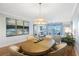 Comfortable dining area with table and seating, opens to living room with sliding glass doors to a balcony at 7892 Sailboat Key S Blvd # 307, South Pasadena, FL 33707