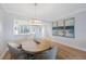 Dining area featuring pendant lighting, a table with seating, and a glimpse into the open kitchen area at 7892 Sailboat Key S Blvd # 307, South Pasadena, FL 33707