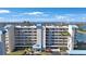Exterior of a multi-story condo building featuring balconies, manicured landscaping, and a scenic view at 7892 Sailboat Key S Blvd # 307, South Pasadena, FL 33707