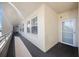 Hallway featuring carpeted floors and a textured wall. The entry door has glass at 7892 Sailboat Key S Blvd # 307, South Pasadena, FL 33707