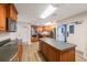 Spacious kitchen boasting a central island, modern appliances, wood cabinets, and open layout at 7892 Sailboat Key S Blvd # 307, South Pasadena, FL 33707