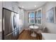 Bright kitchen with stainless steel appliances, white cabinets, and a breakfast nook with bay window at 7892 Sailboat Key S Blvd # 307, South Pasadena, FL 33707