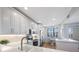 Bright kitchen with stainless steel appliances, white cabinets, and a breakfast nook with bay window at 7892 Sailboat Key S Blvd # 307, South Pasadena, FL 33707