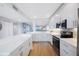 Modern white kitchen featuring stainless steel appliances and ample countertop space at 7892 Sailboat Key S Blvd # 307, South Pasadena, FL 33707