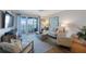 Comfortable living room with a neutral color palette and sliding doors that lead to a waterfront balcony at 7892 Sailboat Key S Blvd # 307, South Pasadena, FL 33707