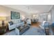 Comfortable living room connected to a dining area, with a sofa, chairs, and waterfront view at 7892 Sailboat Key S Blvd # 307, South Pasadena, FL 33707