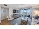 Well-lit living room features a large TV, access to the balcony with stunning views, and comfortable seating at 7892 Sailboat Key S Blvd # 307, South Pasadena, FL 33707