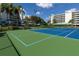 Well-maintained tennis court with vibrant blue and green playing surface, perfect for recreational play at 7892 Sailboat Key S Blvd # 307, South Pasadena, FL 33707