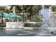 Harbourside entry with lush landscaping, water feature, and beautiful palm trees at 7892 Sailboat Key S Blvd # 307, South Pasadena, FL 33707