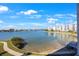 Amazing waterfront view showcasing sparkling water, lush greenery, and a picturesque walking path at 7892 Sailboat Key S Blvd # 307, South Pasadena, FL 33707