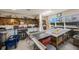 Functional workshop space with ample shelving, tools, workbench, and natural light from a large window at 7892 Sailboat Key S Blvd # 307, South Pasadena, FL 33707