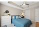 Bright bedroom featuring a ceiling fan, desk, and dresser, all bathed in neutral tones at 800 S Dakota Ave # 323, Tampa, FL 33606