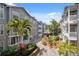 Charming courtyard with palm trees, lush landscaping, and inviting seating areas at 800 S Dakota Ave # 323, Tampa, FL 33606