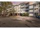 Charming multi-story condominium building featuring private balconies and secure gated access at 800 S Dakota Ave # 323, Tampa, FL 33606