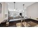 Bright kitchen with breakfast bar, stainless sink, granite countertops, and pendant lighting overlooking the living space at 800 S Dakota Ave # 323, Tampa, FL 33606