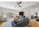 Inviting living room with large windows, ceiling fan, modern decor, and an open doorway to the bedroom at 800 S Dakota Ave # 323, Tampa, FL 33606