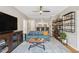Open concept living room with hardwood floors, large television, and a seamless transition into the kitchen and bar area at 800 S Dakota Ave # 323, Tampa, FL 33606