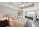Cozy main bedroom featuring a tray ceiling, neutral tones, ample natural light, and a dedicated workspace at 800 S Dakota Ave # 323, Tampa, FL 33606