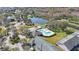 An aerial shot showcases a community pool, lake, and surrounding trees at 8004 Downpatrick Ct, Tampa, FL 33610