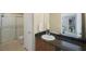 Bathroom featuring a shower, vanity, and a large mirror at 8004 Downpatrick Ct, Tampa, FL 33610