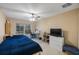 Bedroom with large windows offering views of the outdoors, with a ceiling fan and a desk at 8004 Downpatrick Ct, Tampa, FL 33610