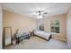 Well-lit bedroom features a ceiling fan, two windows, and neutral decor at 8004 Downpatrick Ct, Tampa, FL 33610