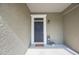 Front door with welcome mat, and decorative 'Home' sign at 8004 Downpatrick Ct, Tampa, FL 33610