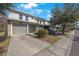 Townhome exterior showing attached garage, and manicured lawn at 8004 Downpatrick Ct, Tampa, FL 33610