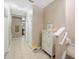 Bright hallway featuring access to the kitchen and stairs to the second floor at 8004 Downpatrick Ct, Tampa, FL 33610