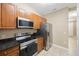 Well-equipped kitchen with stainless steel appliances and a view to the hallway and the front door at 8004 Downpatrick Ct, Tampa, FL 33610