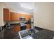 Kitchen with dark granite countertops, stainless steel appliances, and tiled floor at 8004 Downpatrick Ct, Tampa, FL 33610