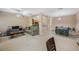Open-concept living and dining area with neutral paint, ceiling fan, and carpeted floors at 8004 Downpatrick Ct, Tampa, FL 33610