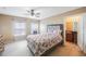 Main bedroom featuring windows, a ceiling fan, and a view to the bathroom at 8004 Downpatrick Ct, Tampa, FL 33610