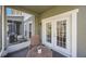 Cozy patio area featuring double doors, a screened window, and a small table at 8004 Downpatrick Ct, Tampa, FL 33610