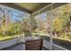 Relaxing screened porch with a lovely view of the surrounding trees at 8004 Downpatrick Ct, Tampa, FL 33610