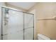 Enclosed shower features sliding glass doors and updated fixtures at 8004 Downpatrick Ct, Tampa, FL 33610