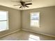 Cozy bedroom features neutral walls, a ceiling fan, and natural light at 808 20Th W Ave, Bradenton, FL 34205