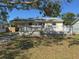 Charming single-story home featuring a cozy front porch, lush lawn, and convenient covered parking at 808 20Th W Ave, Bradenton, FL 34205