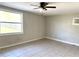 Neutral living room with a ceiling fan, tile flooring, and natural light from a large window at 808 20Th W Ave, Bradenton, FL 34205