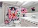 Bathroom with light cabinets, shower with curtain and fashion decor at 9040 Lunar Ln, Port Richey, FL 34668