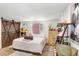 Bedroom with barn door, wood floors, a window, and playful decor at 9040 Lunar Ln, Port Richey, FL 34668